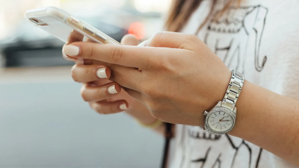 Woman typing on her mobile phone.
