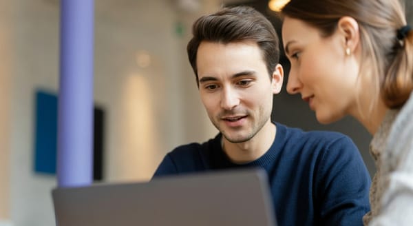 Man and woman looking at a laptop computer screen.