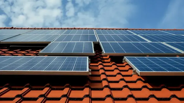 Home roof solar panels on terracotta roof.