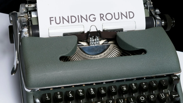Typewriter with 'funding round' written on paper.